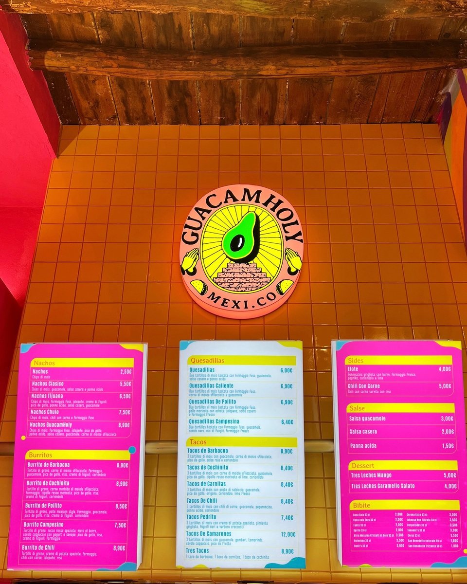 Brightly lit lightbox signs at a Mexican take-away restaurant