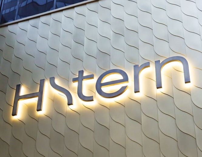 Backlit metal sign displaying the name of the jewelry store in elegant lettering.