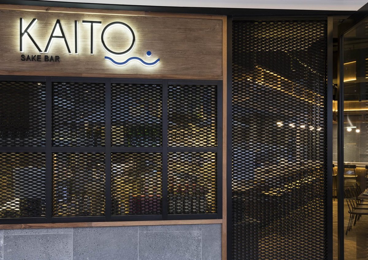 Illuminated backlit sign featuring the restaurant's logo with a soft glow in the background.